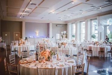 Elegant reception venue with decorated tables and floral arrangements